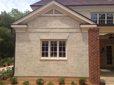 acid wash brick house beige metal roof|limewash exterior brick.